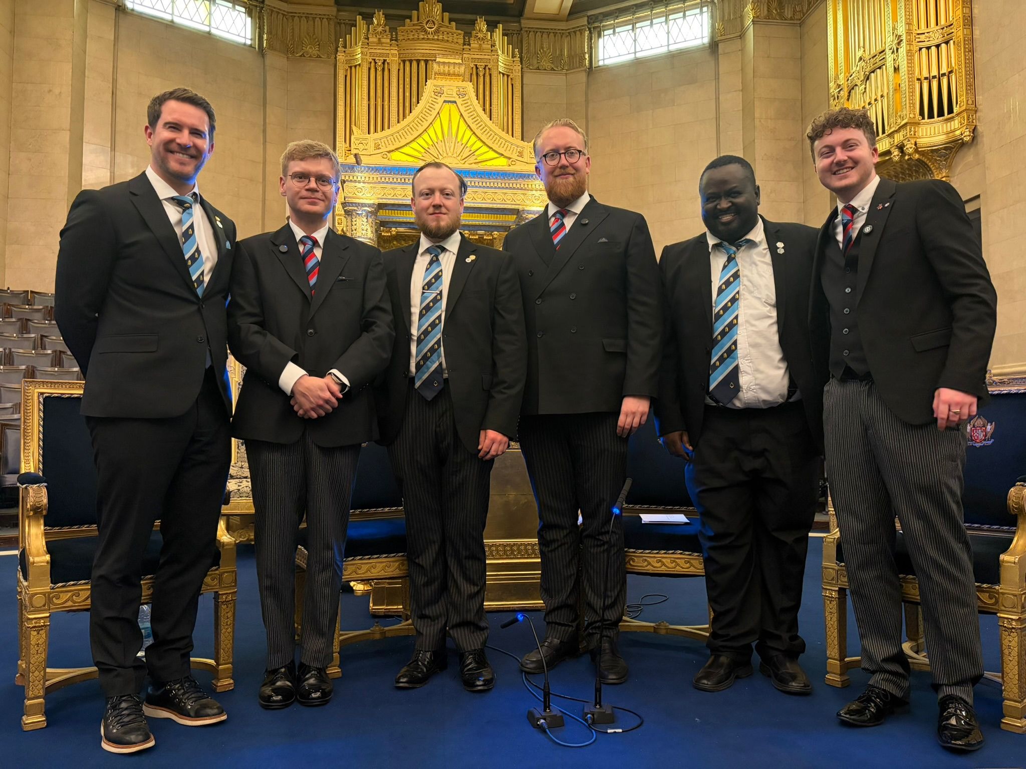 Six members of David Garrick Lodge in formal dark suits and Masonic ties at Freemasons' Hall